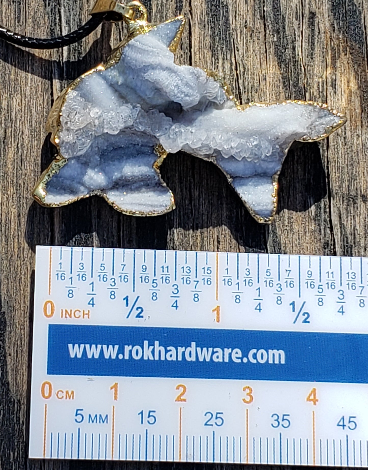 Druzy dolphin necklace shown for size reference