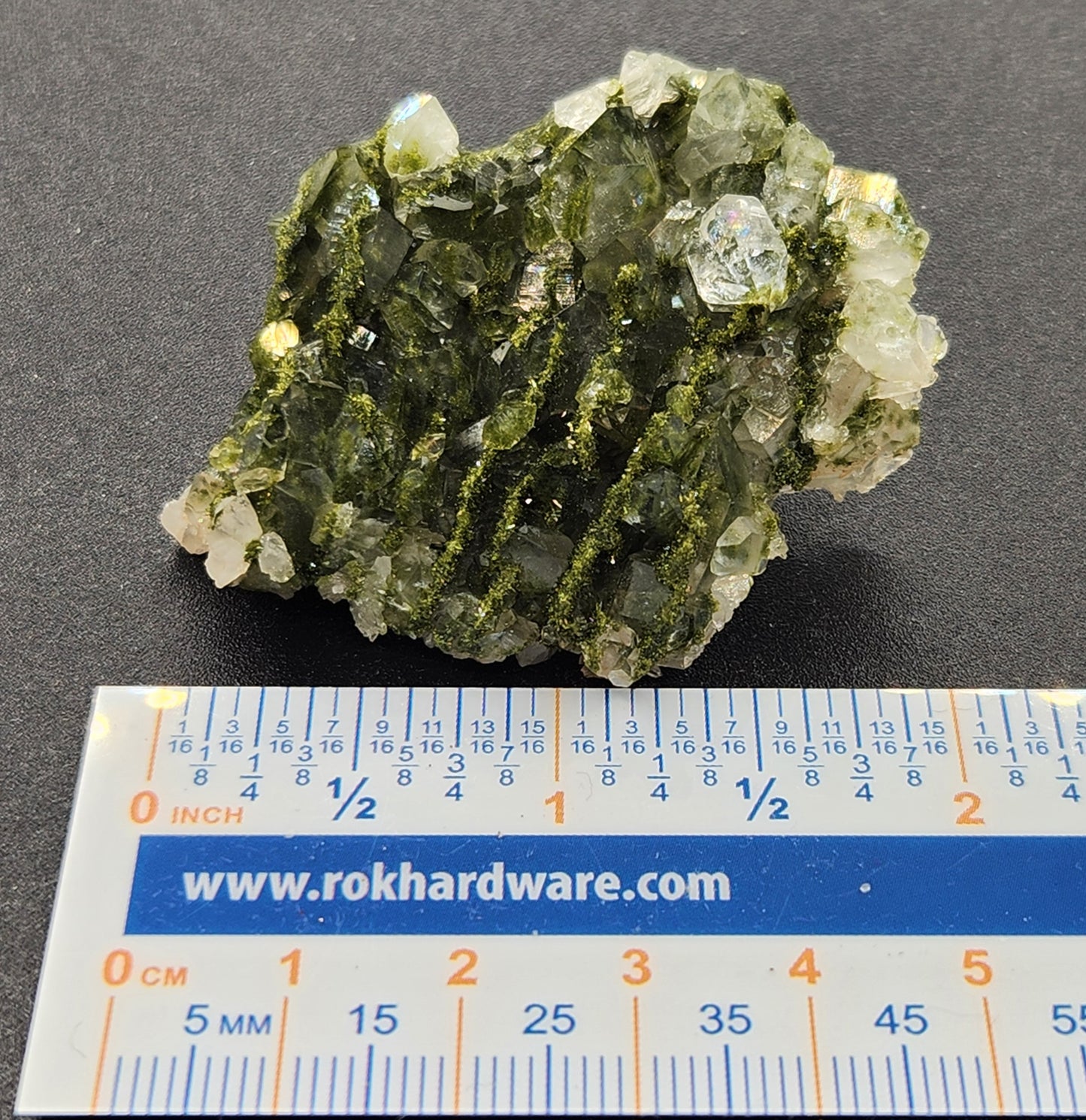 Forest epidote with quartz mineral photographed showing size. SP466