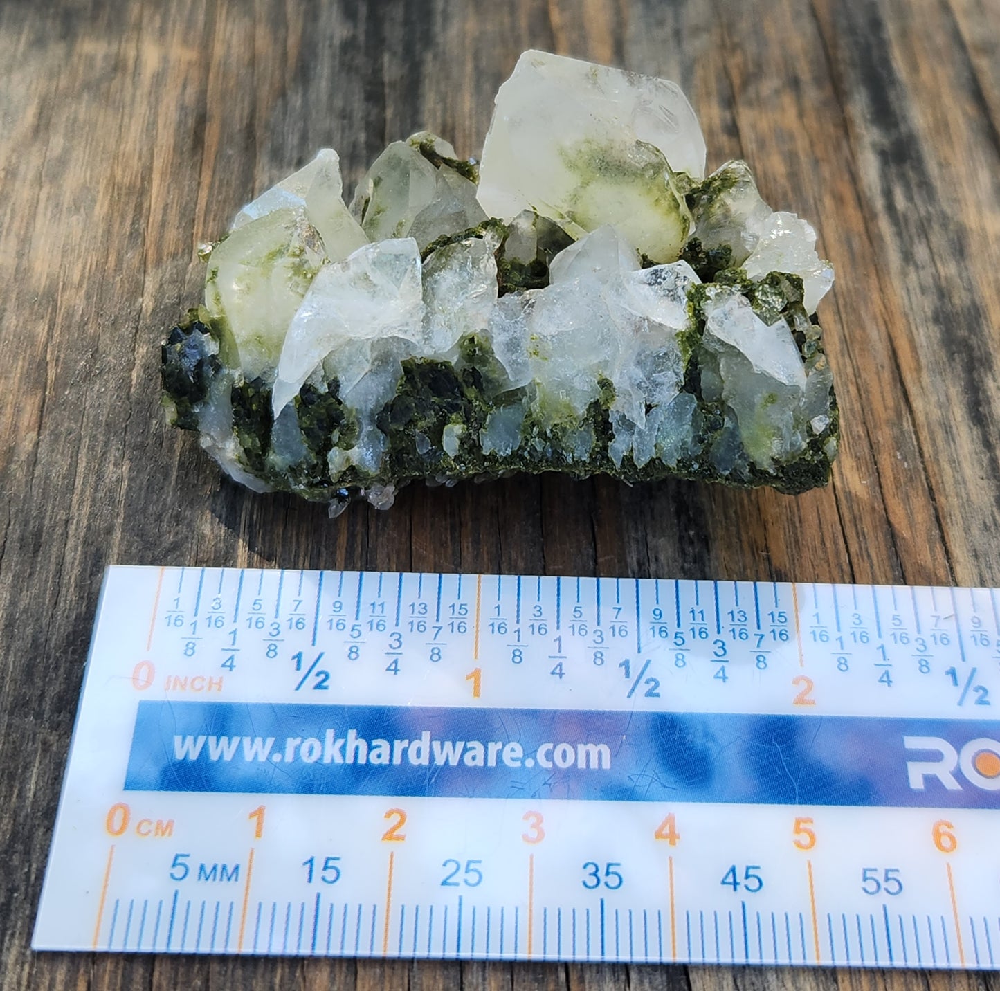 Forest epidote with quartz mineral photographed showing size. SP461