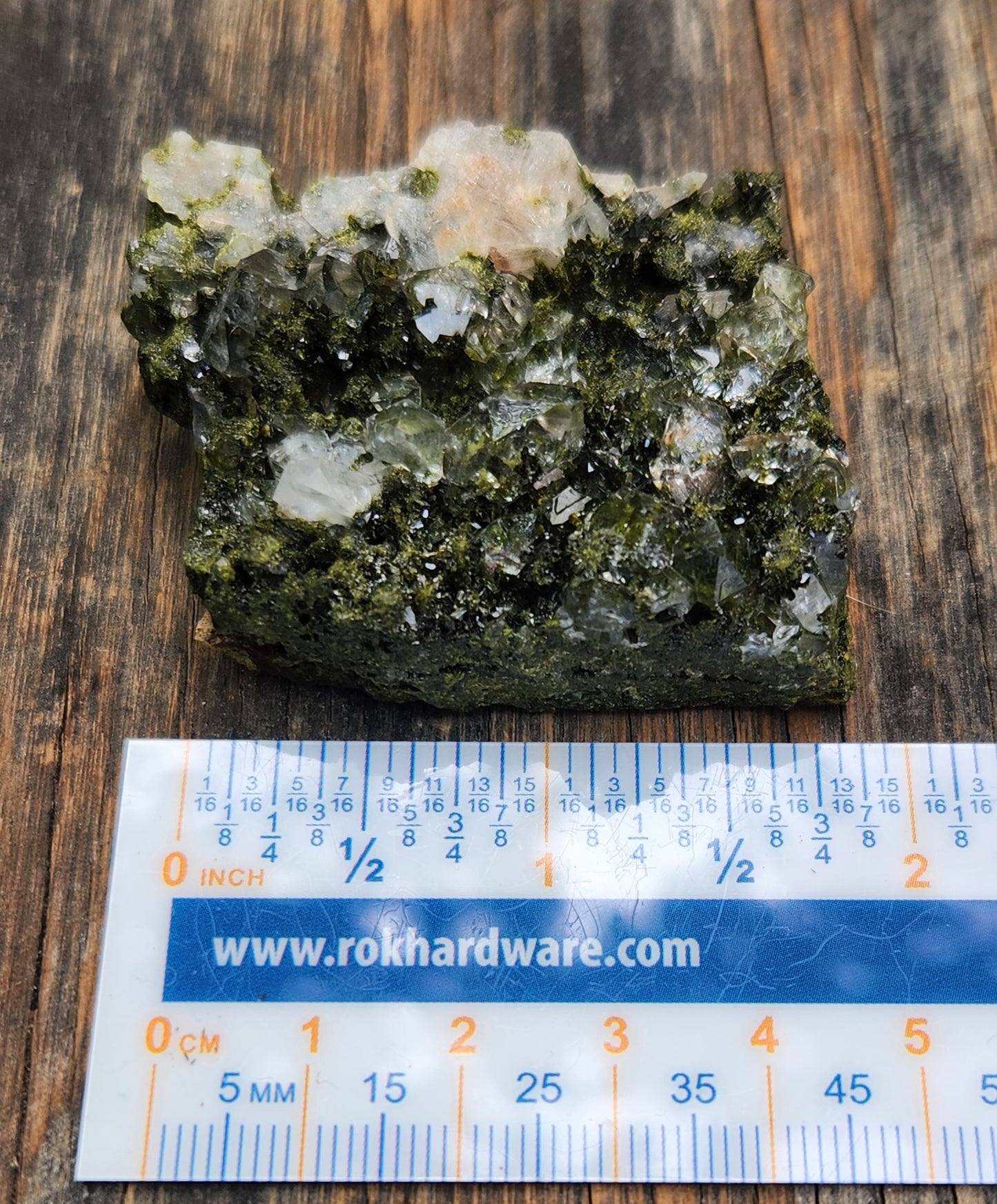 Forest epidote with quartz mineral photographed showing size. SP465