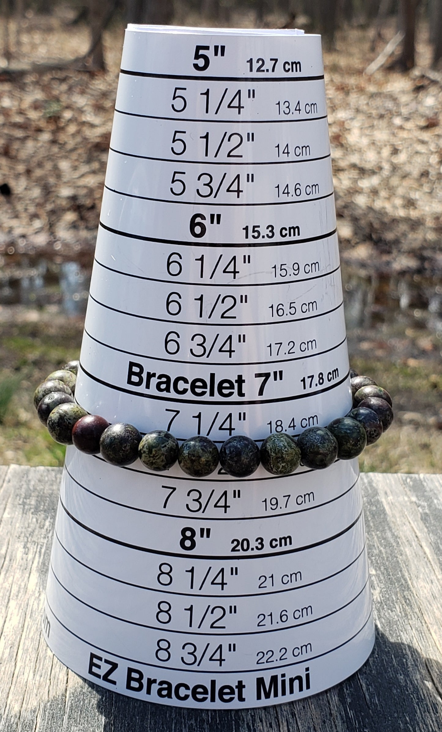 Handmade Dragon’s Blood men’s bracelet on jewelry sizer