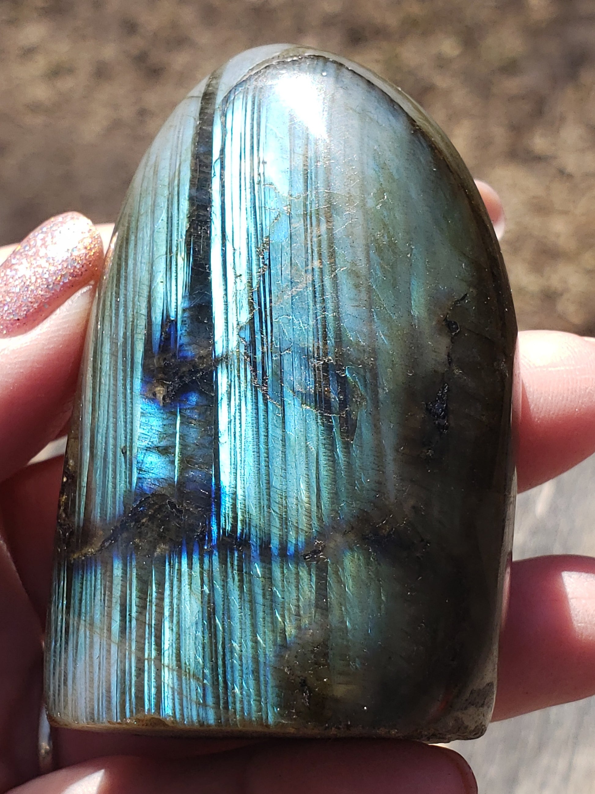 Polished labradorite freeform crystal showing vibrant blue and teal flash with natural striated patterning FF04
