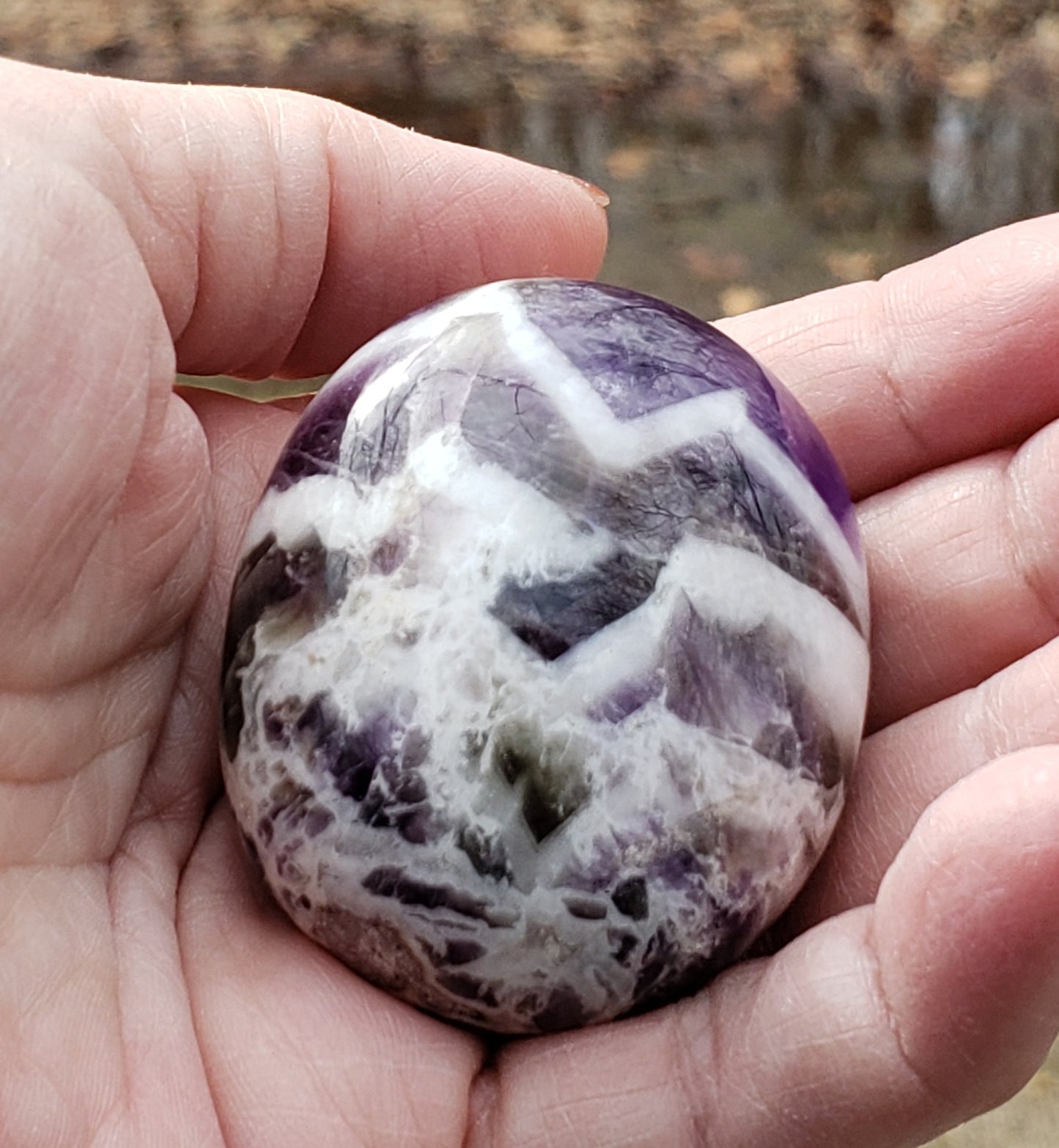 Polished chevron amethyst palm stone highlighting natural banding and smooth finish PS07-3