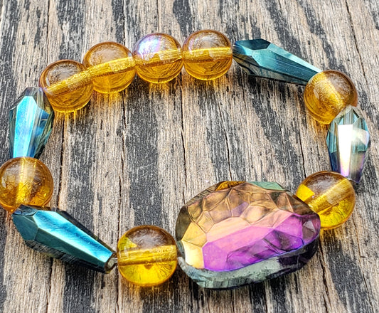 glass beaded stretch bracelet with amber, purple, and blue colored beads 