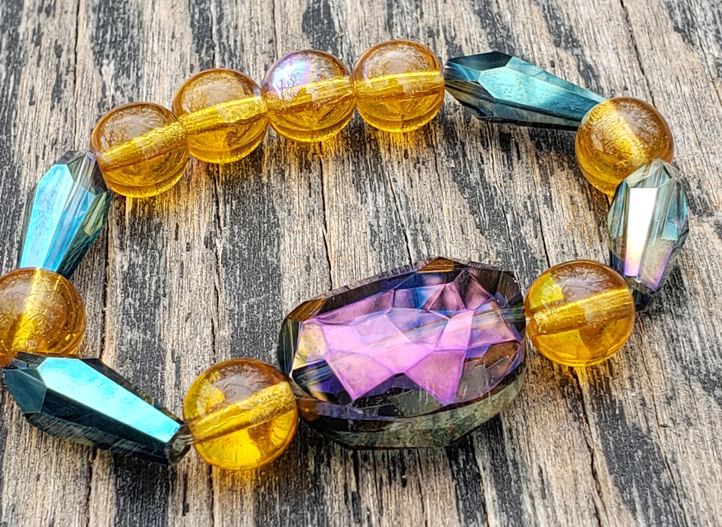 Amber, purple and blue glass beaded stretch bracelet close up