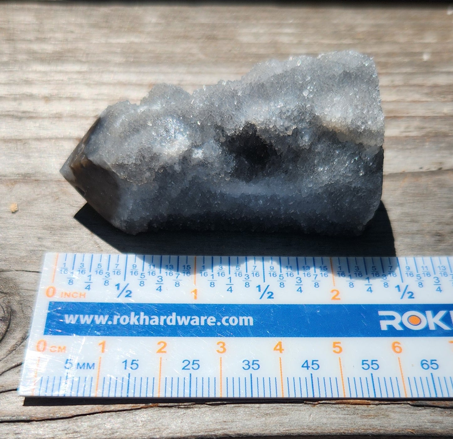 Natural black sphalerite crystal tower showing druzy texture ruler
