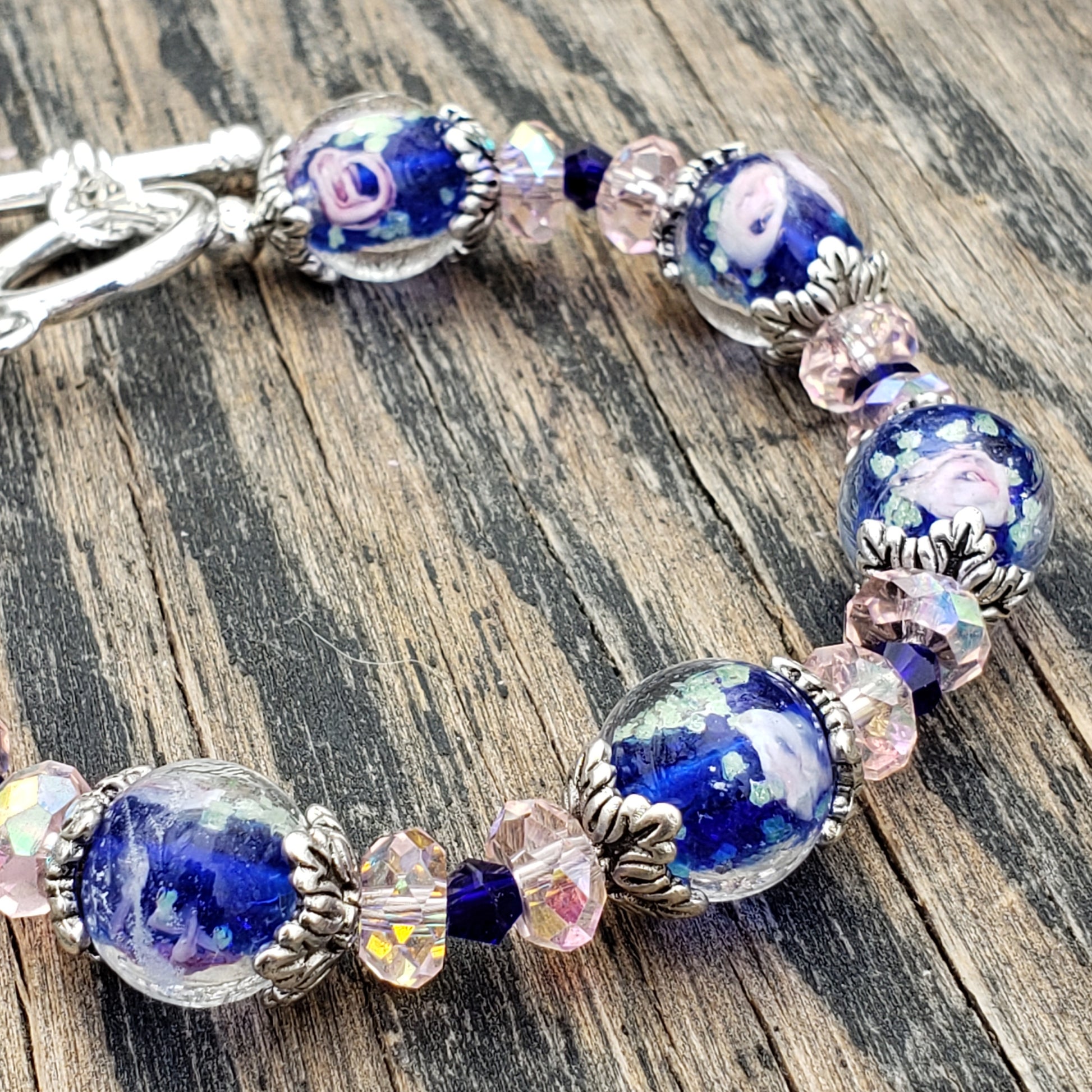 Handmade blue and pink flower lampwork glass beaded bracelet with toggle clasp close up