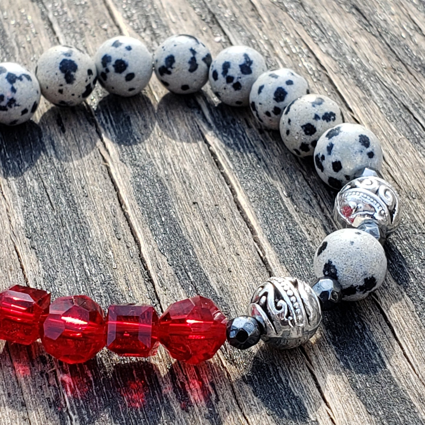 dalmatian jasper and red glass stretch bracelet close up