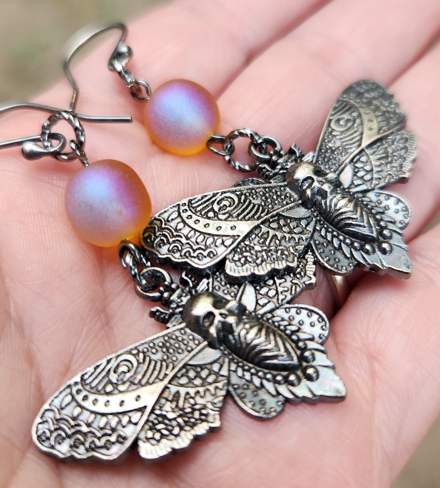Death’s Head Moth sterling silver dangle earrings in hand