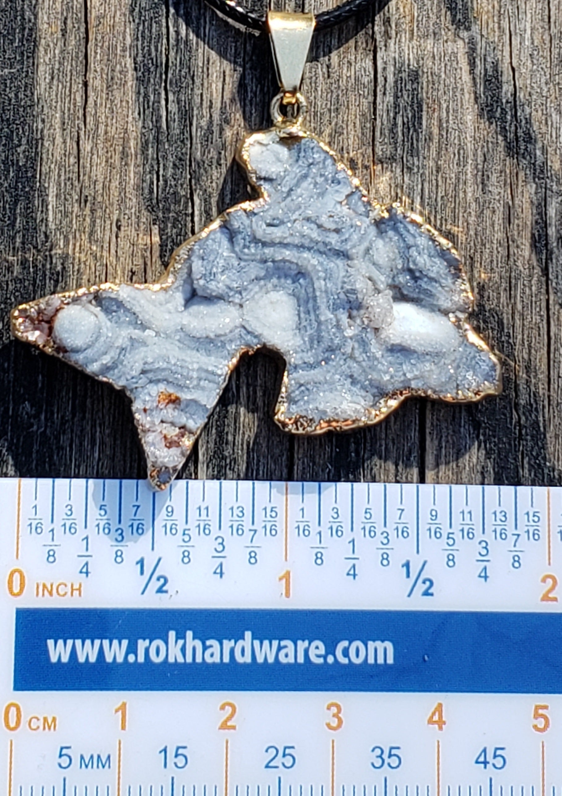 Druzy dolphin necklace shown for size reference