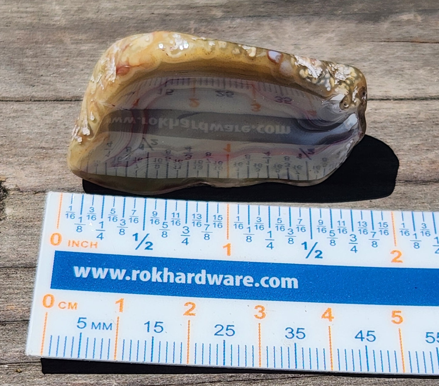 Mexican agate shown on ruler for scale TA326