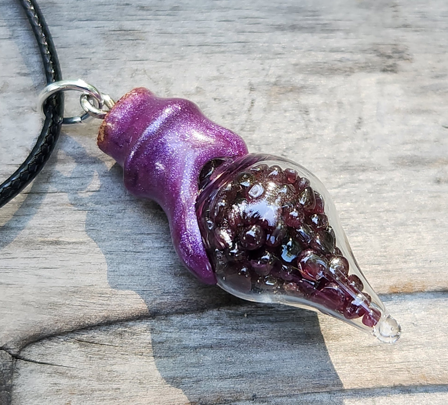 Tumbled garnet gemstone necklace in glass bottle pendant