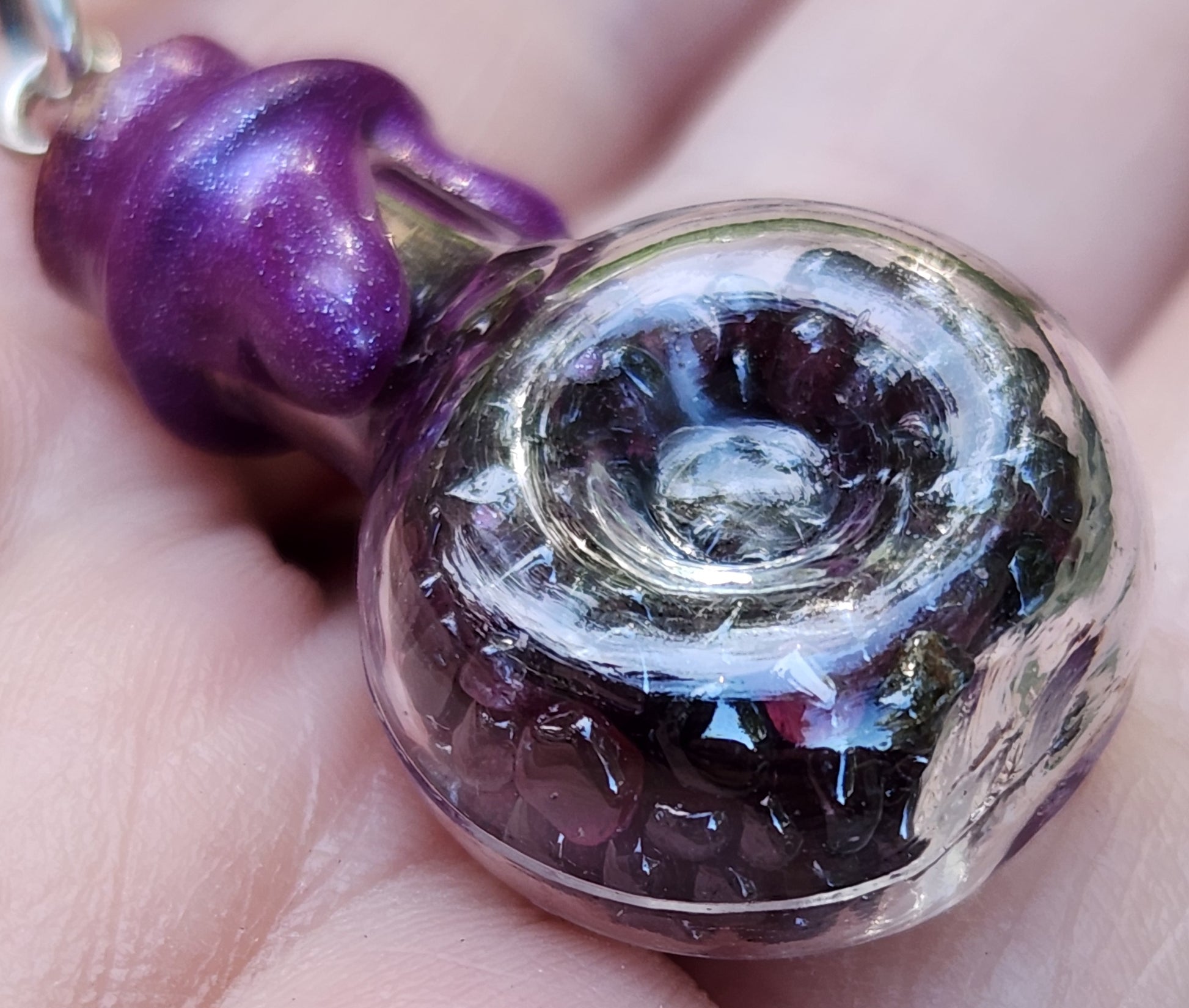 Tumbled garnet gemstone necklace in glass bottle pendant close up