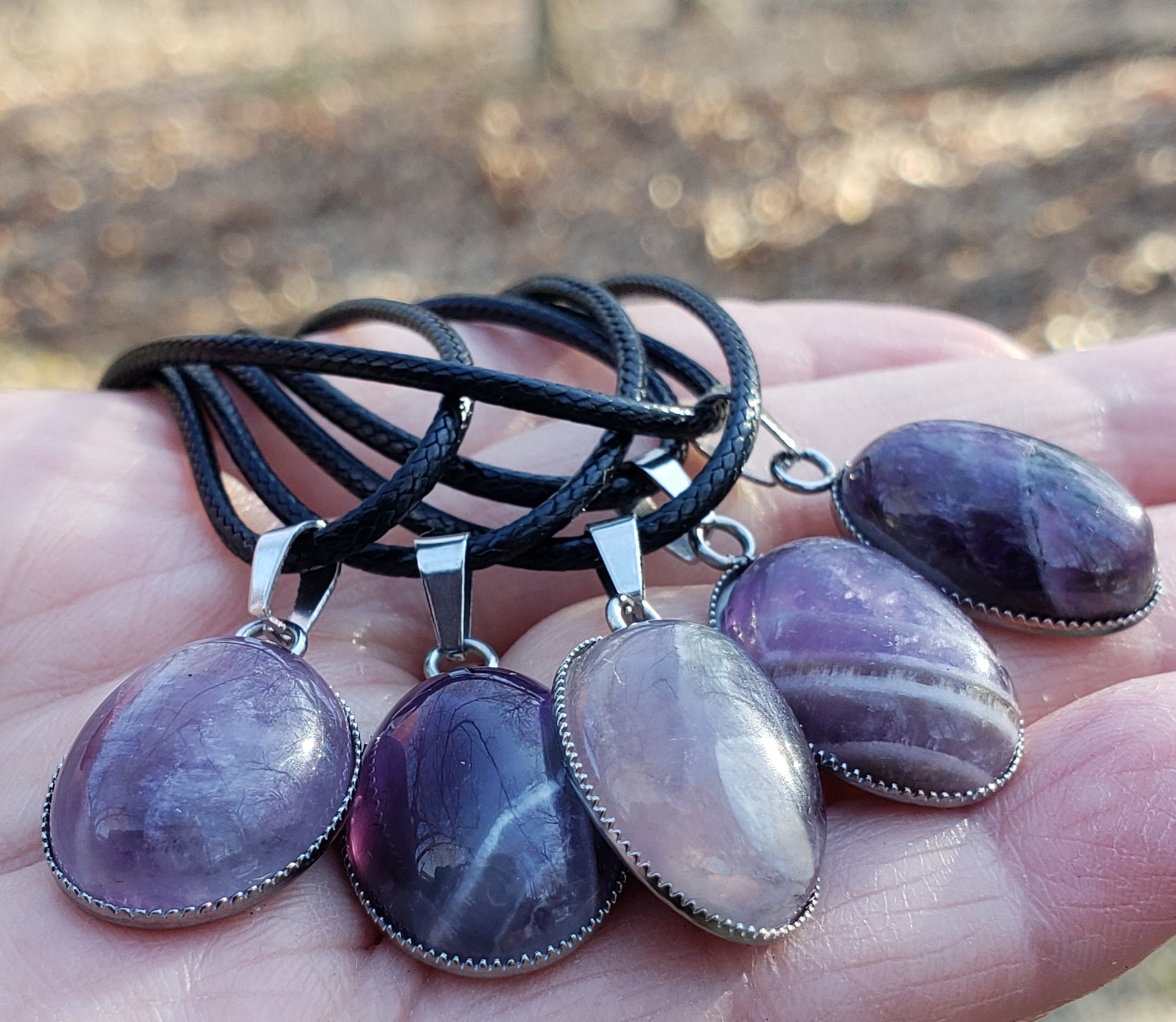 Handmade amethyst necklace in hand