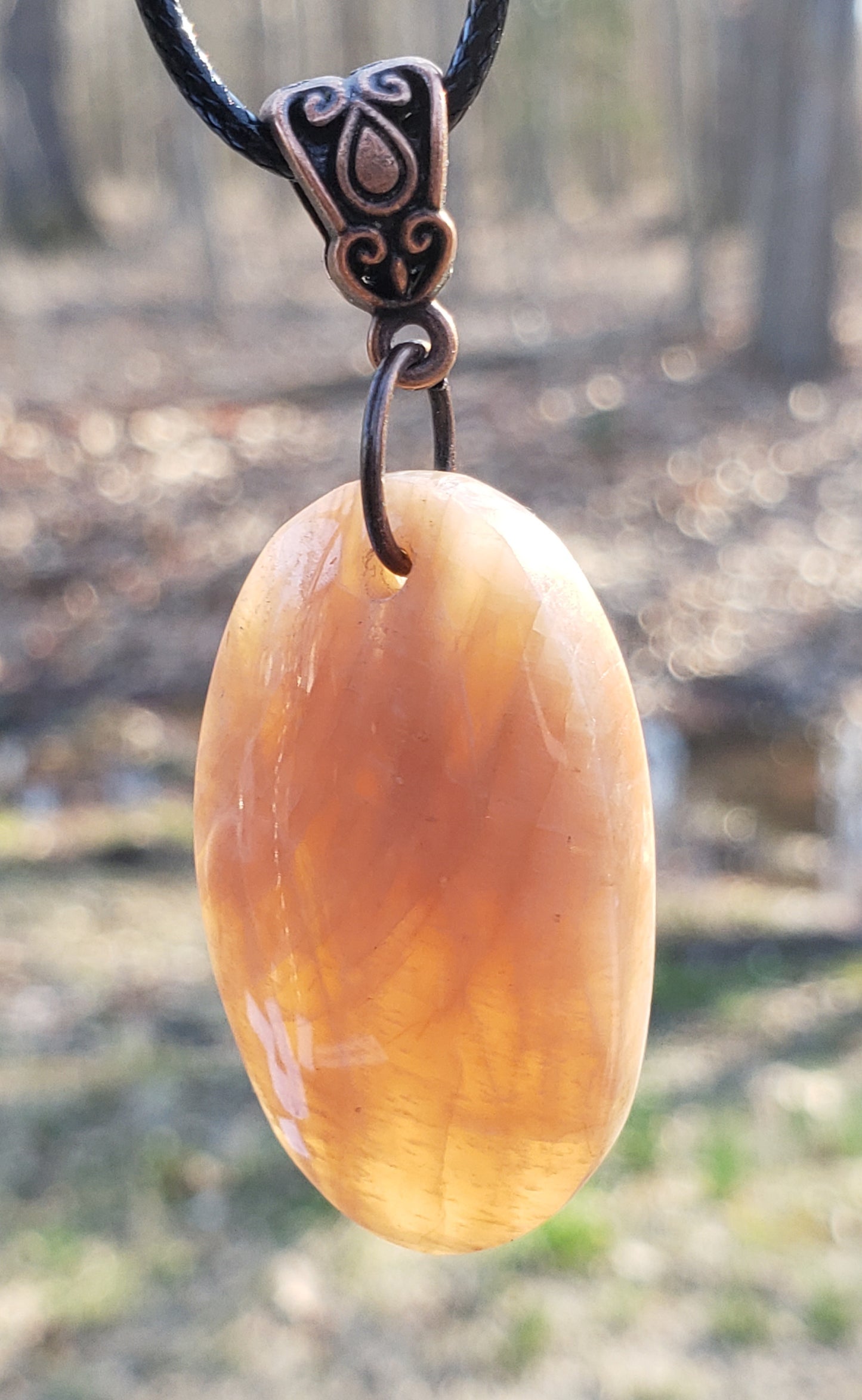 Handmade peach moonstone necklace in sun