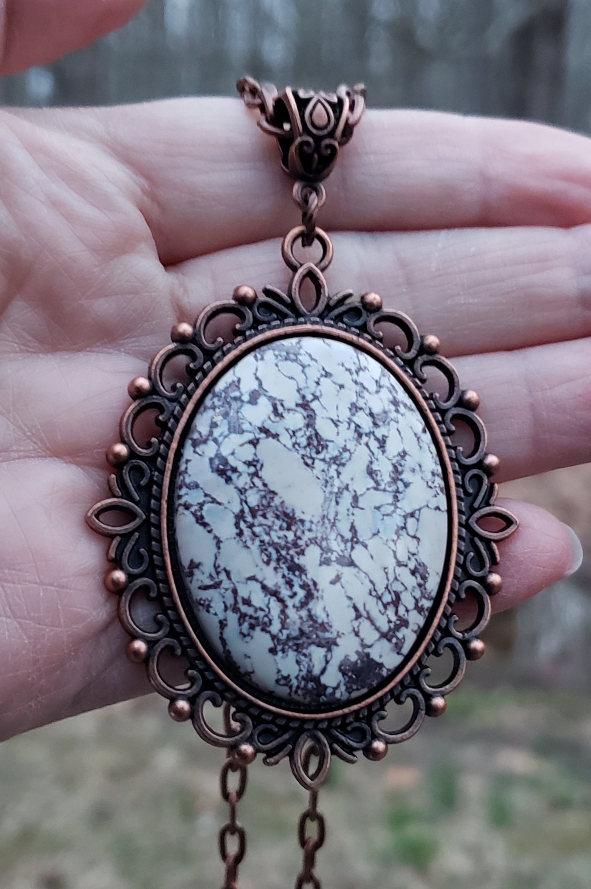 Viper jasper necklace held in hand for size