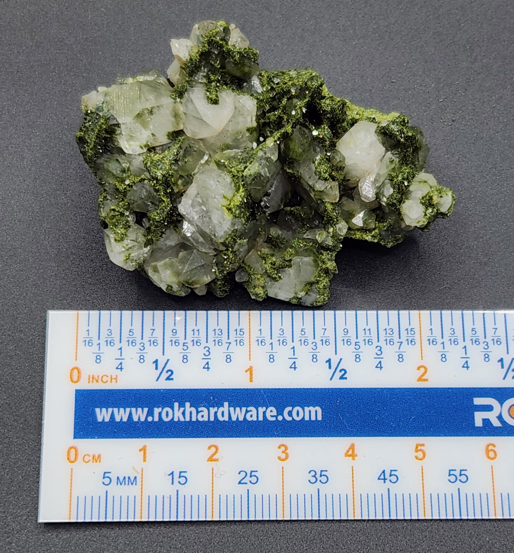 Forest epidote with quartz mineral photographed showing size. SP452