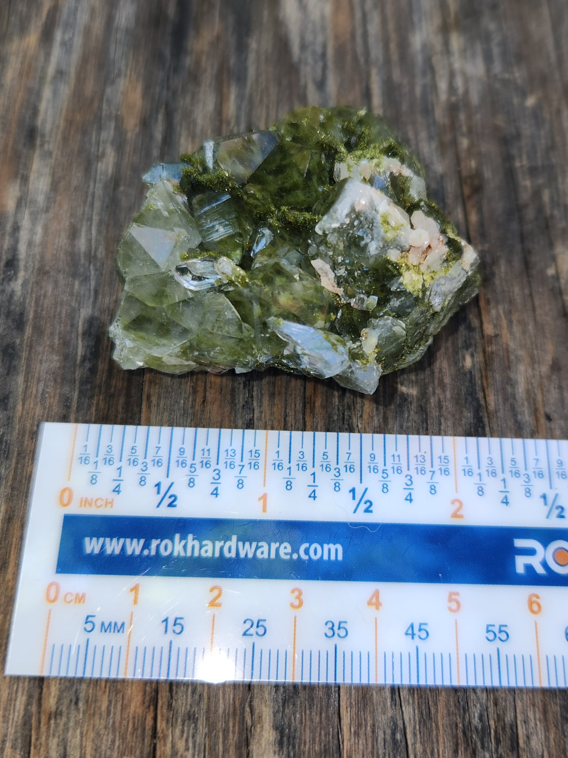 Forest epidote with quartz mineral photographed showing size. SP455