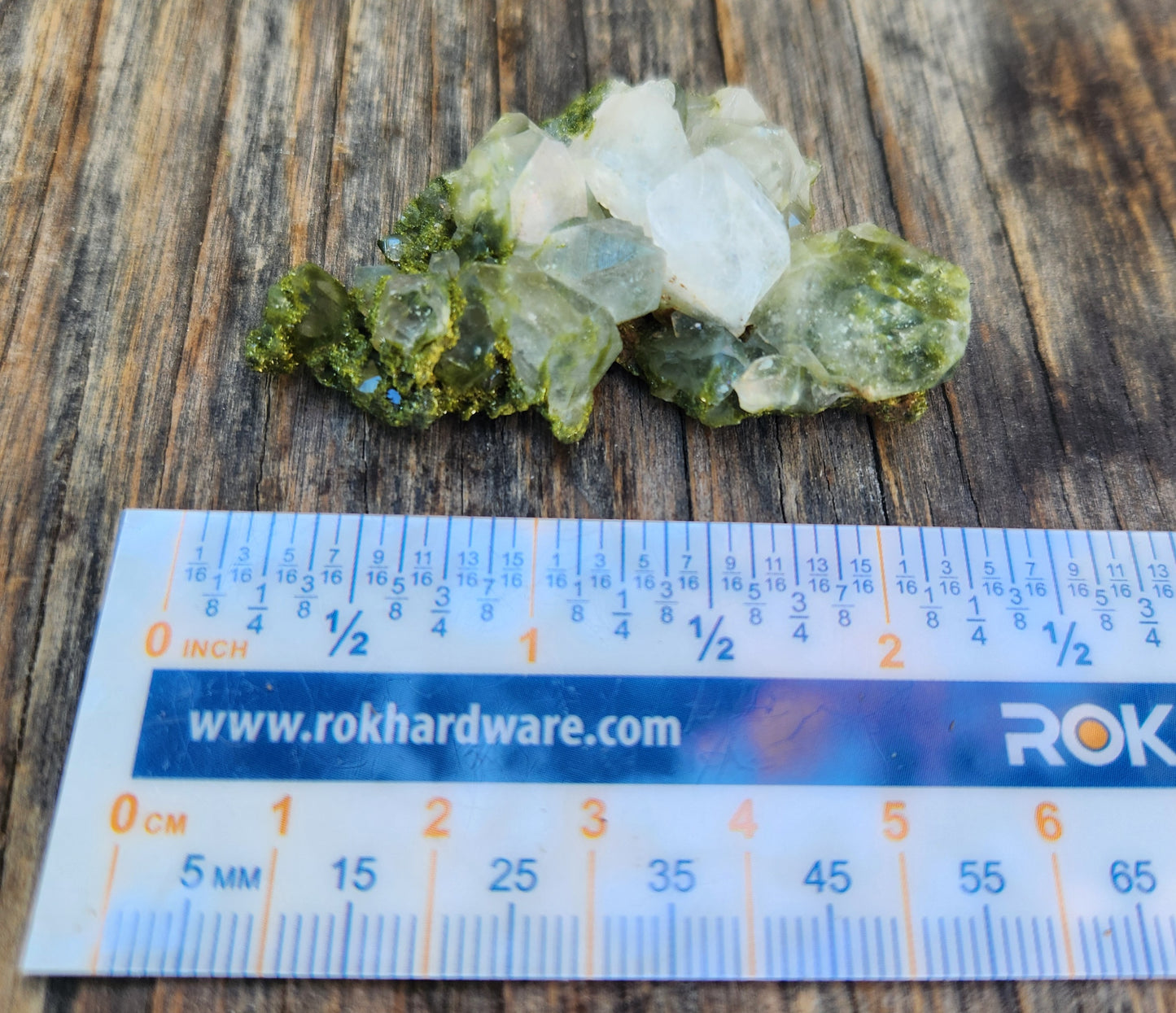 Forest epidote with quartz mineral photographed showing size. SP459