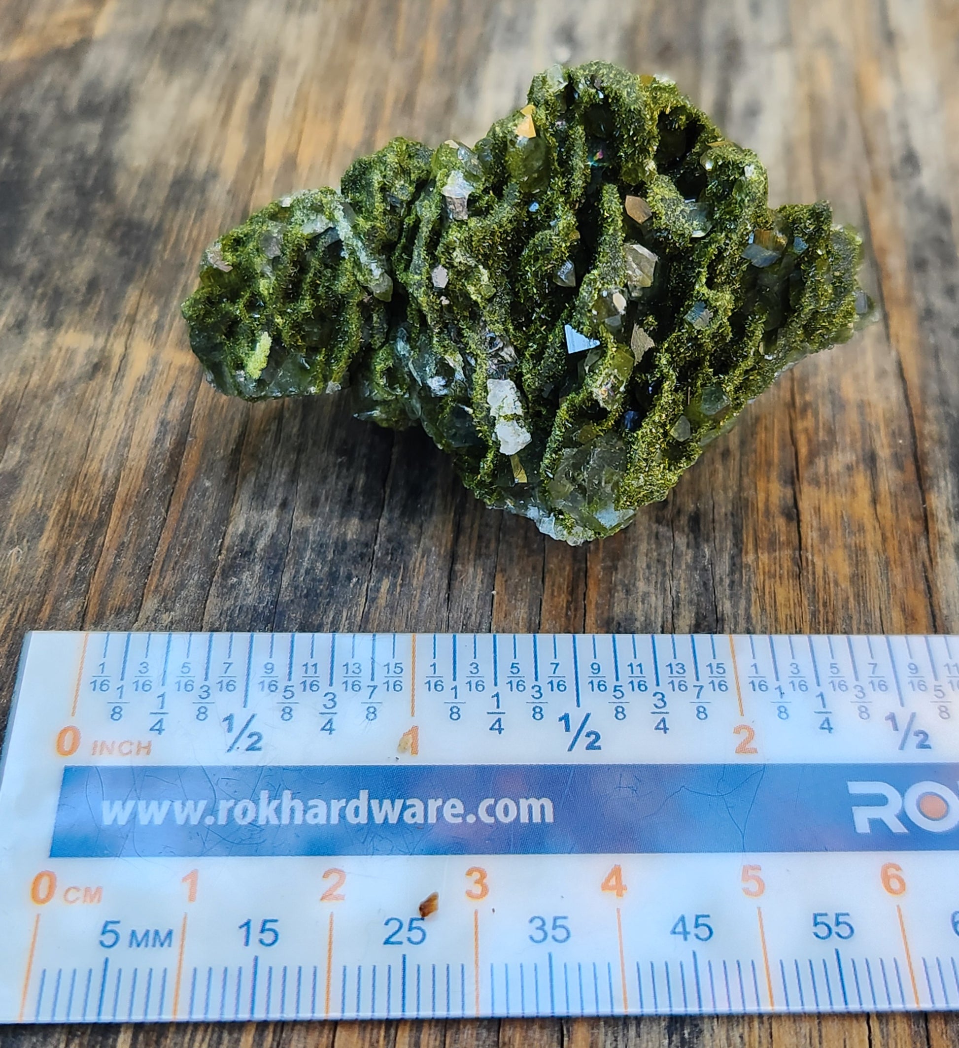 Forest epidote with quartz mineral photographed showing size. SP460