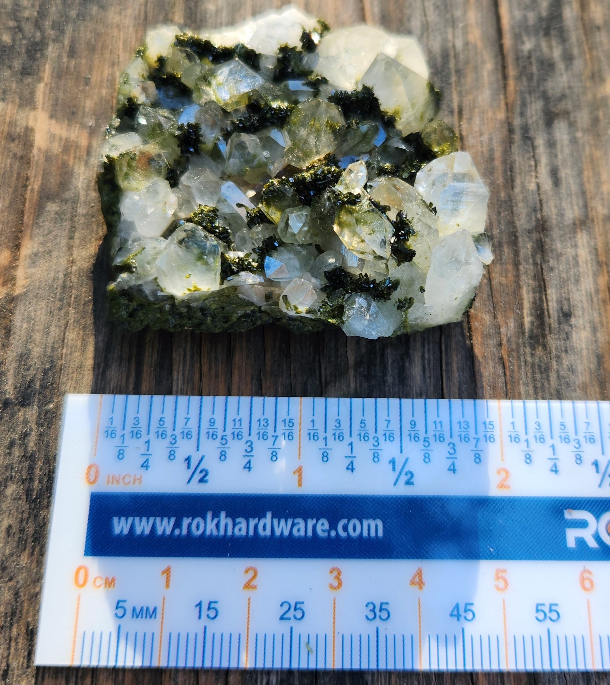 Forest epidote with quartz mineral photographed showing size and structure. SP472