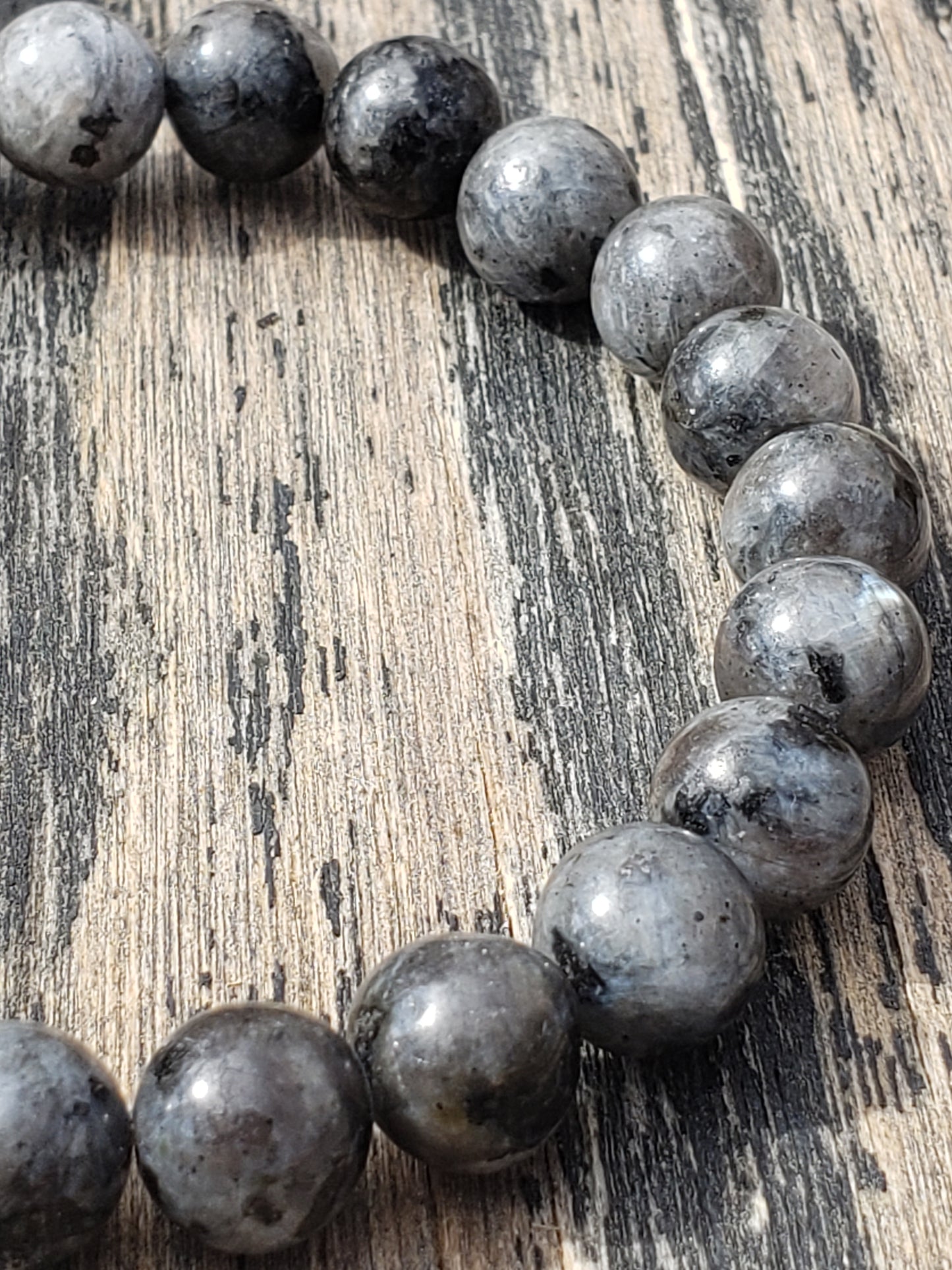 Larvikite stretch bracelet with dark gray gemstone beads close up shimmer