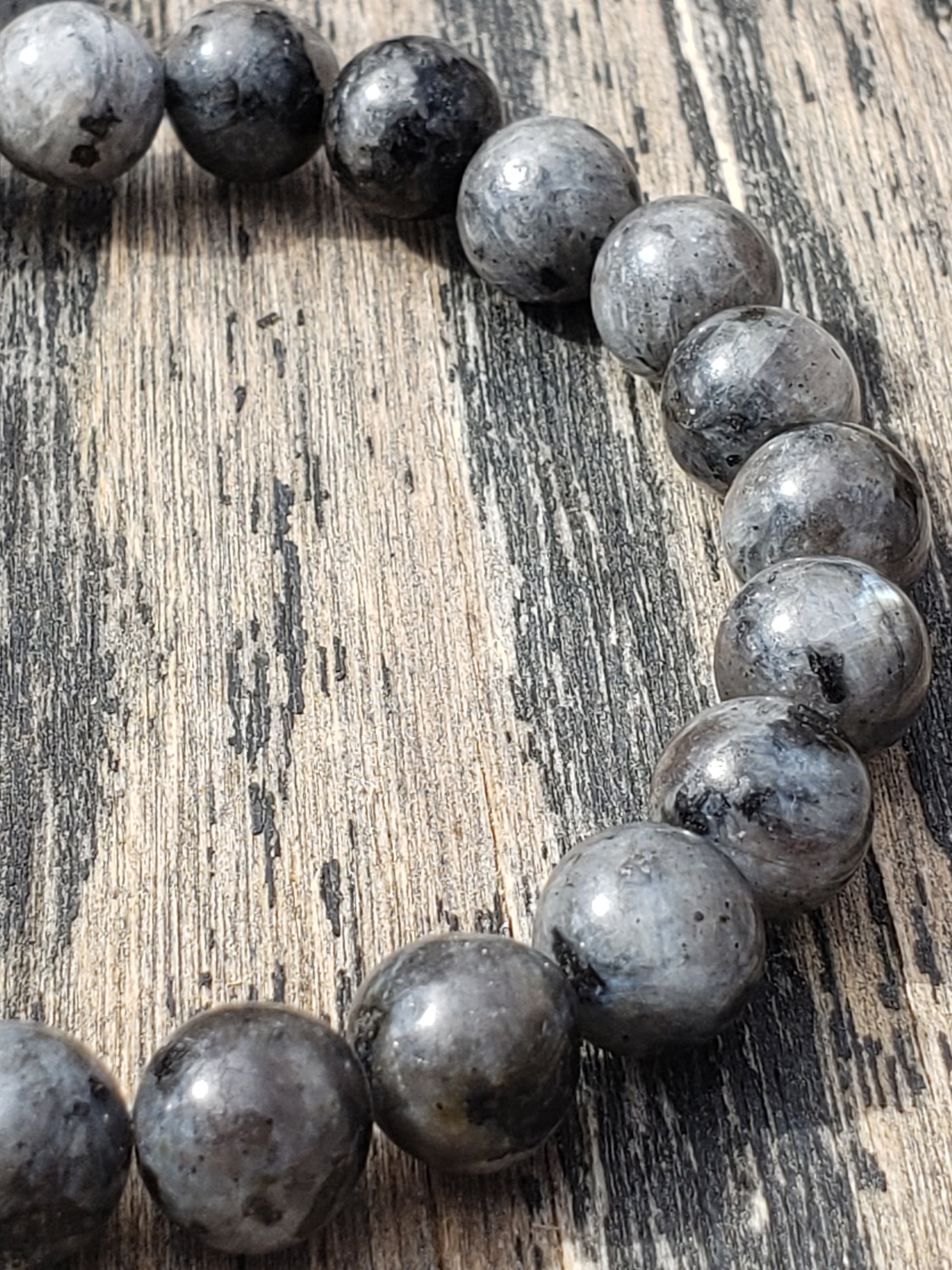 Larvikite stretch bracelet with dark gray gemstone beads close up shimmer