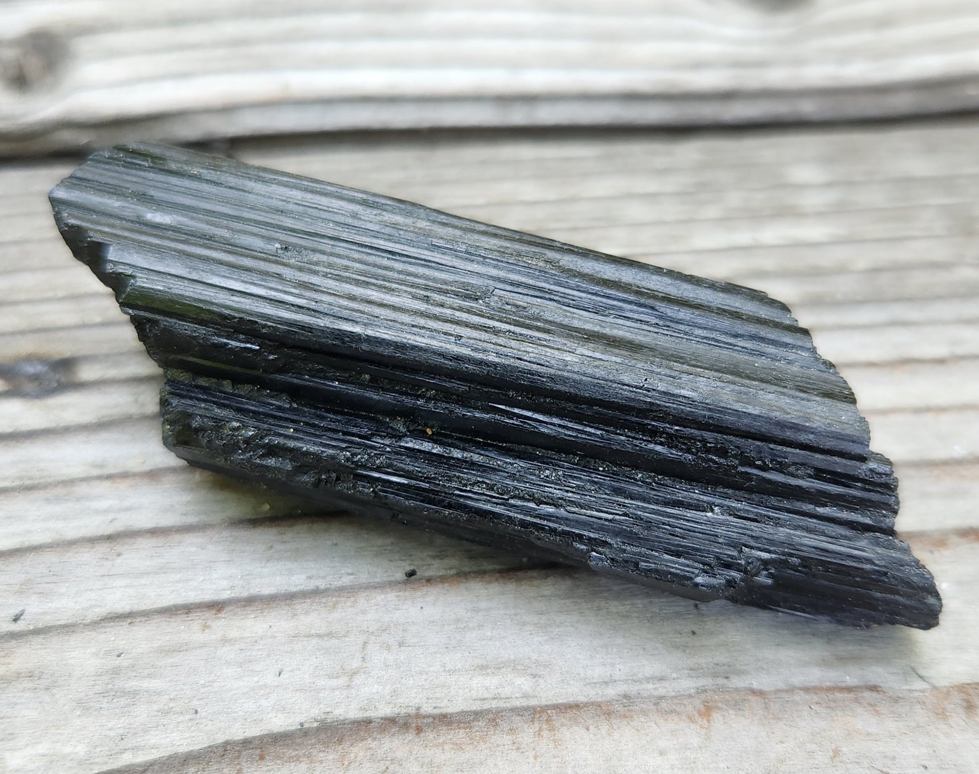 Rough black tourmaline mineral specimen with well-defined striation texture, item RC428