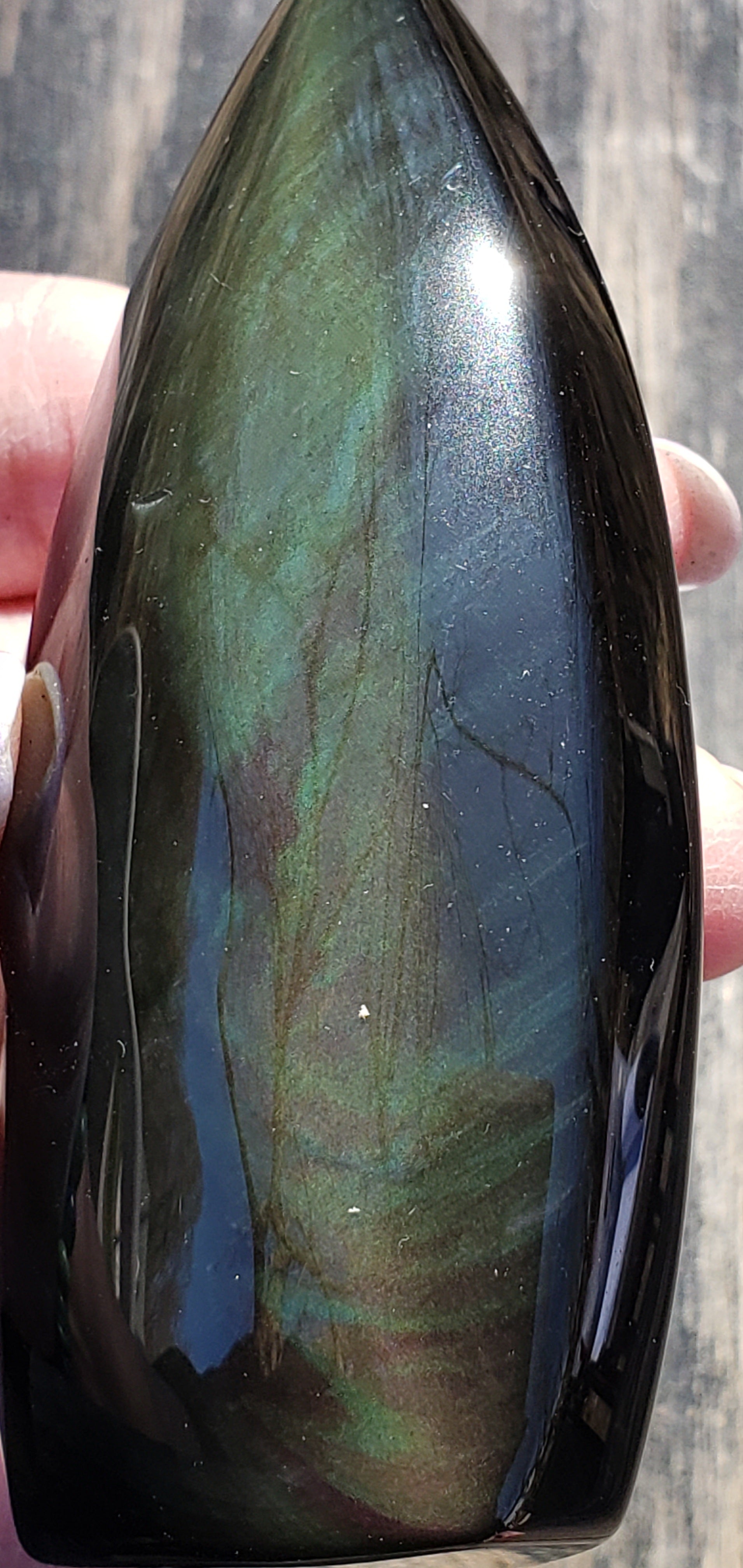 Natural rainbow obsidian freeform flame high flash side view