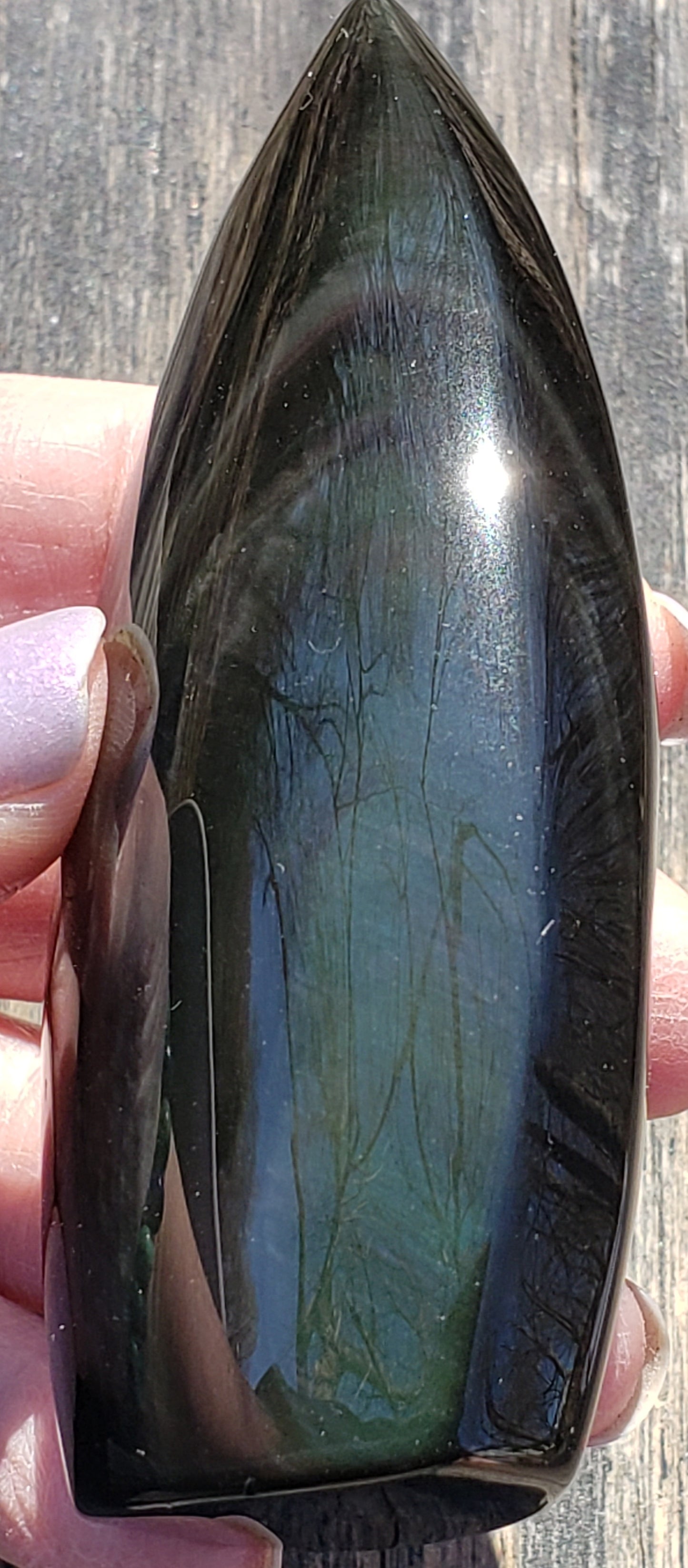 Natural rainbow obsidian freeform flame side view