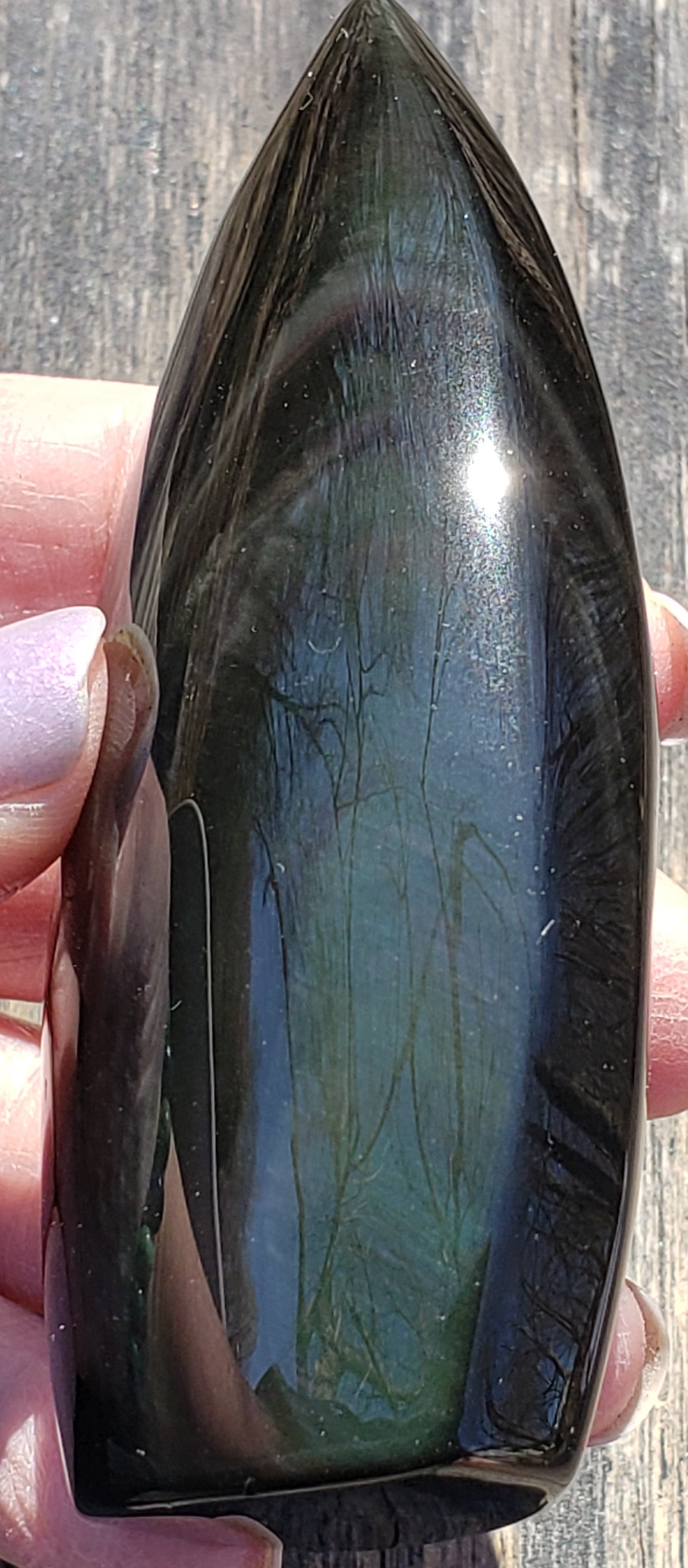Natural rainbow obsidian freeform flame side view