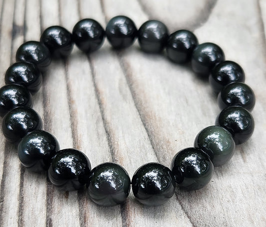 Close-up of rainbow obsidian beads on stretch bracelet