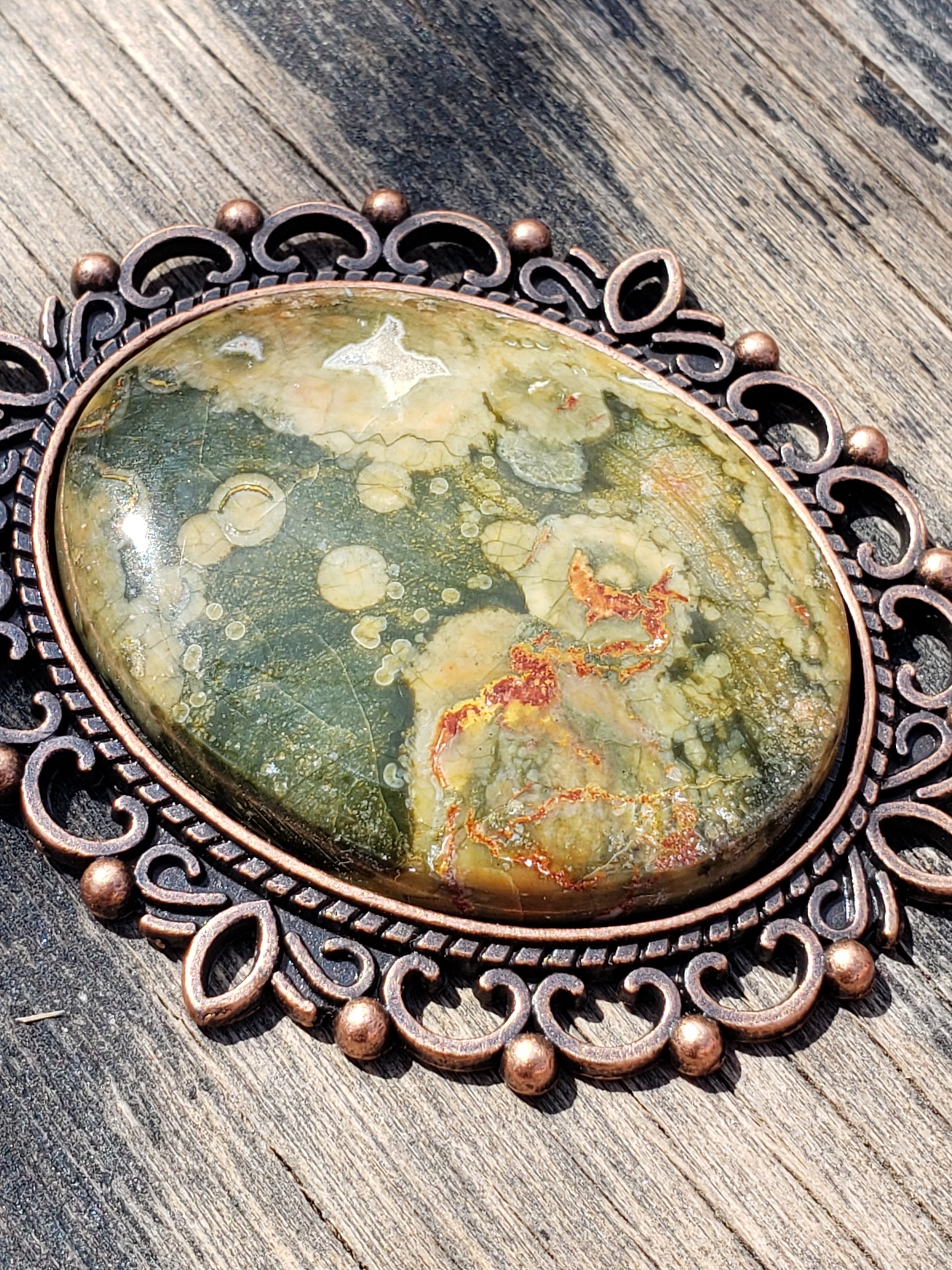 Rainforest jasper and rhyolite necklace with 40×30 mm stone pendant in sunlight