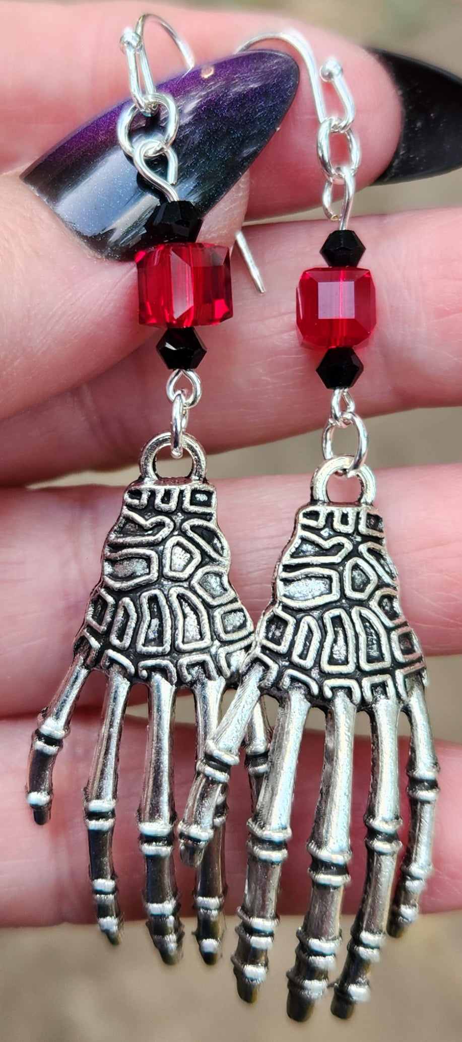 Handmade skeleton hand sterling silver earrings close up