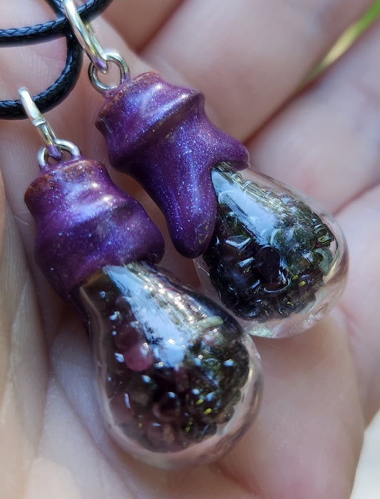 Tumbled garnet gemstone necklace in glass bottle pendant