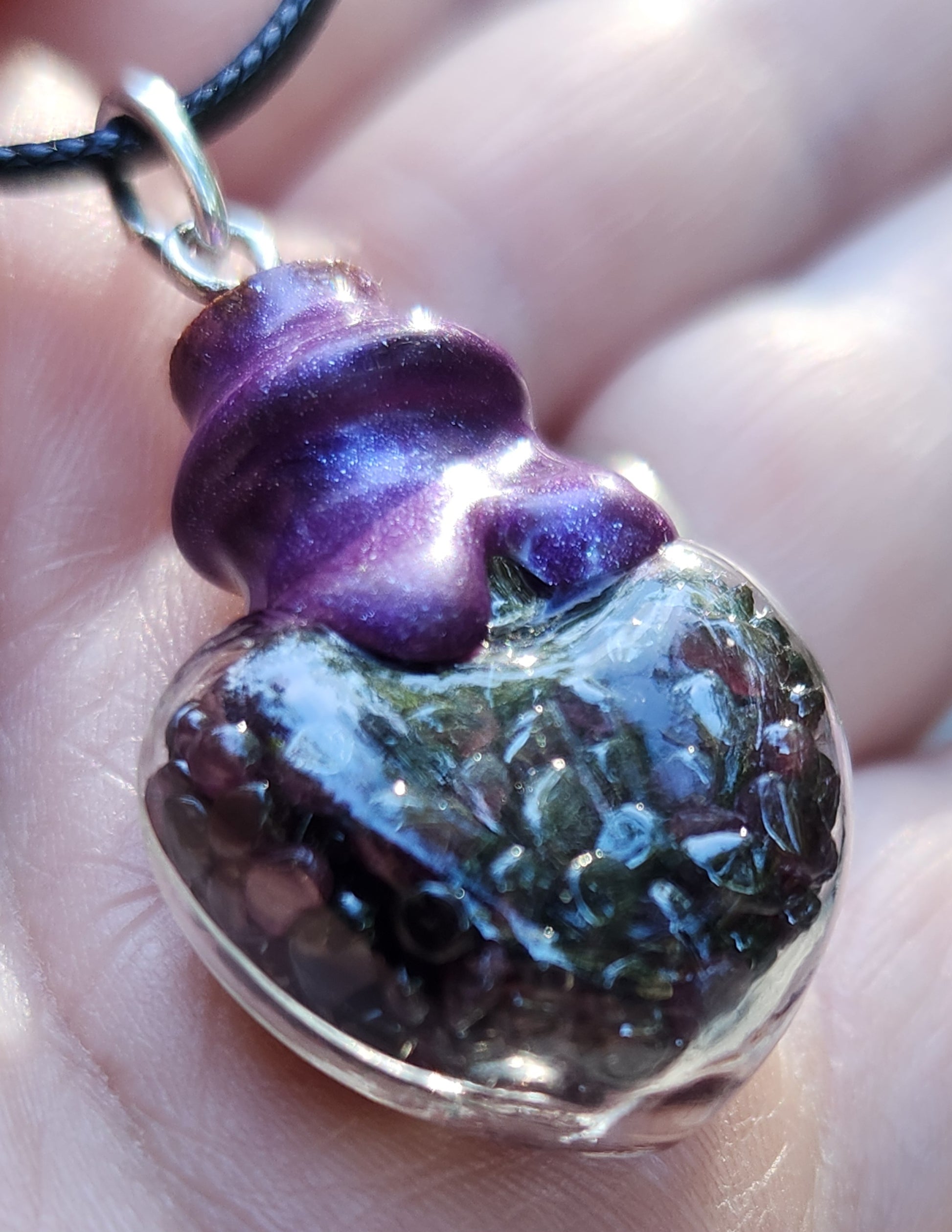 Tumbled garnet gemstone necklace in glass bottle pendant