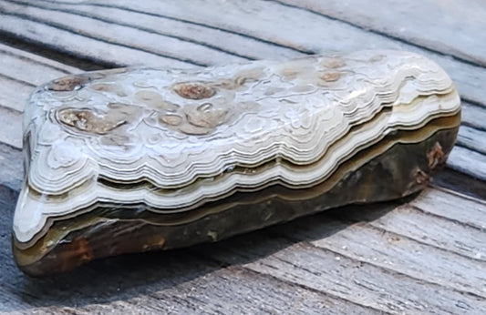 In-house tumbled Mexican Crazy Lace Agate with layered horizontal banding, TA359