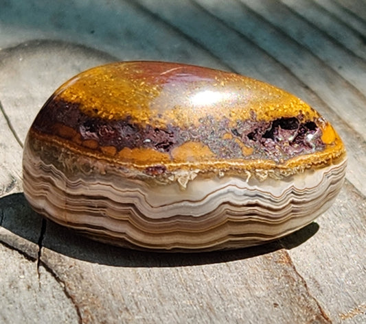 Polished Mexican Crazy Lace Agate featuring iron-toned cap and natural cavity openings, TA362
